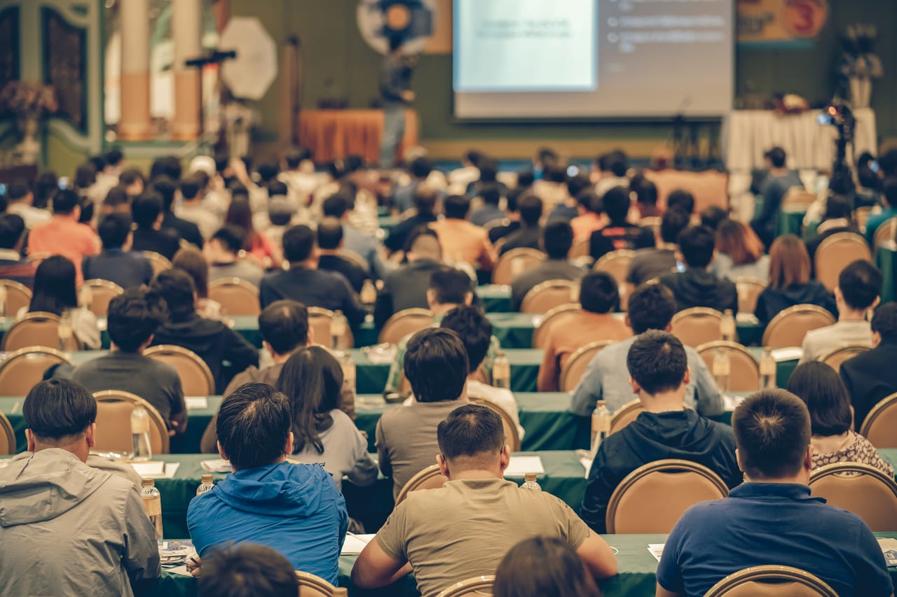 An engaged audience watching a presentation at a conference