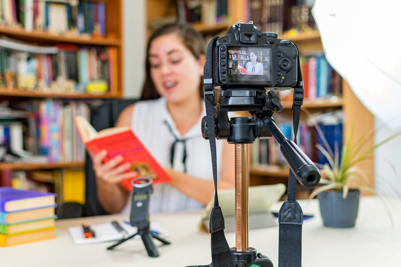 A homeschool content creator filming herself reading a book aloud
