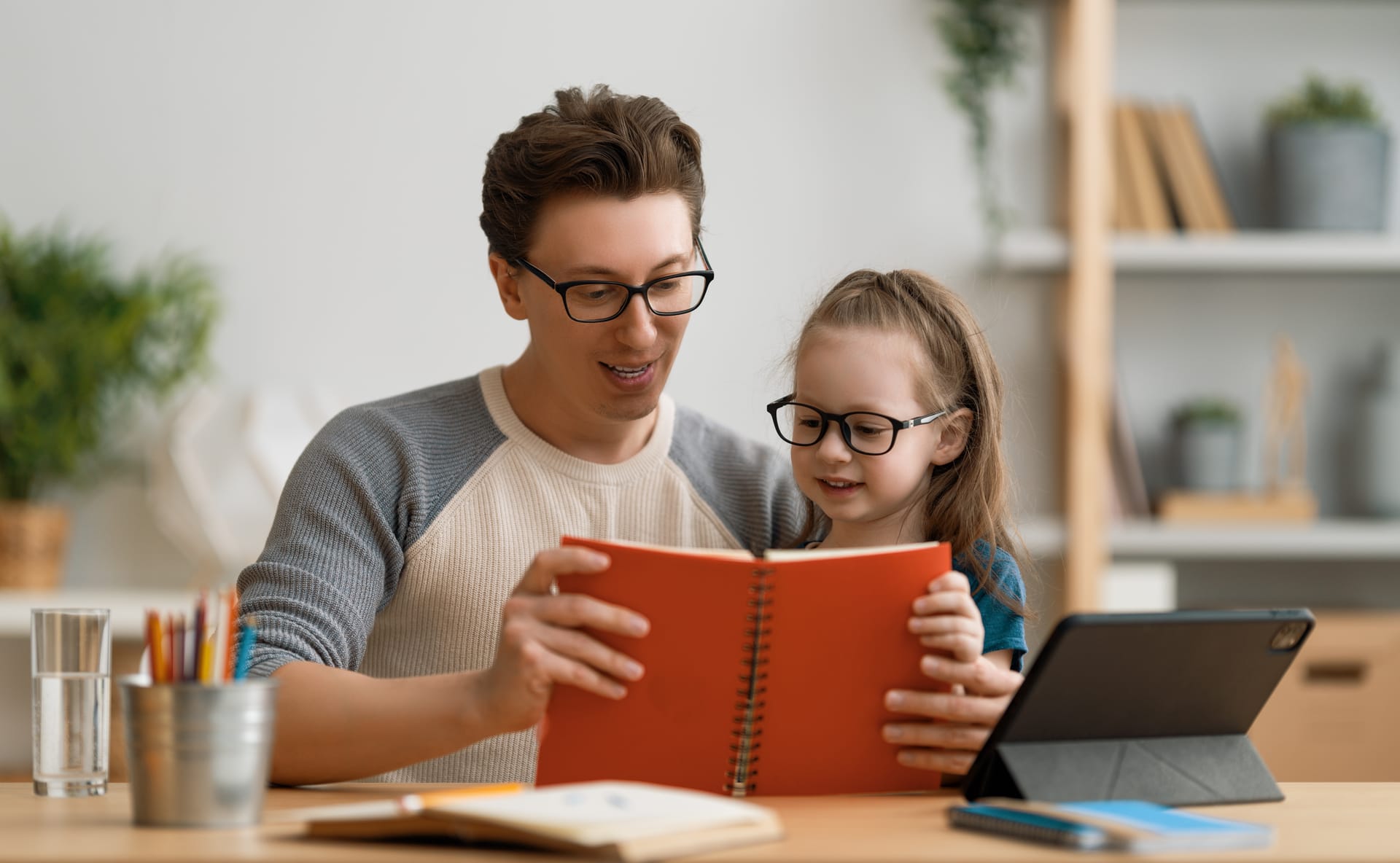 Dad reading with his kids at home
